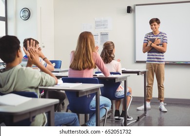 Schoolboy giving presentation in classroom at school - Powered by Shutterstock