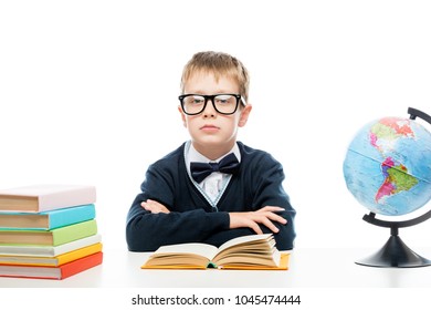 schoolboy with glasses at the table while studying