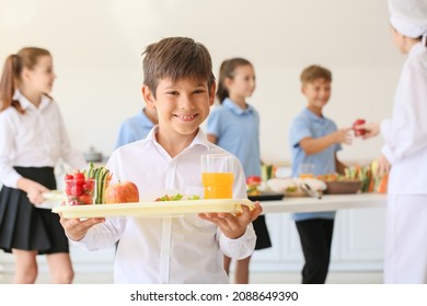 Schoolboy having lunch in school canteen - Shutterstock ID 2088649390