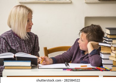 Schoolboy with his tutor do homework.