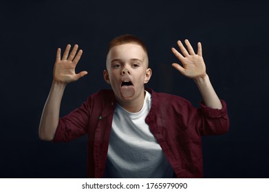 Schoolboy Makes Face Leaning Against The Glass