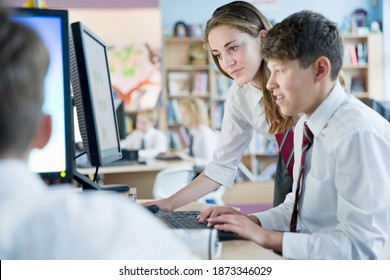 Schoolboy And Schoolgirl In Private School Uniform Sharing Computer In The Computer Lab