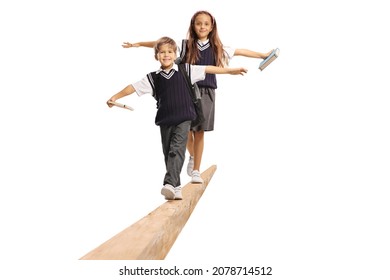 Schoolboy And Schoolgirl Walking On A Wooden Beam Isolated On White Background