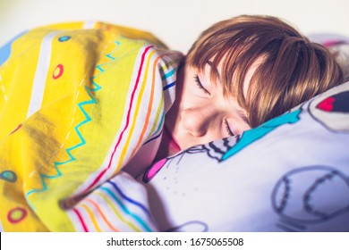 Schoolboy sleeps in his bed. One day of ordinary life - Shutterstock ID 1675065508