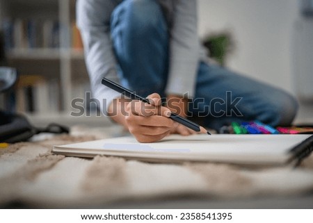 a schoolboy Small caucasian boy play at home draw on the floor doing homework childhood development growing up and education concept copy space domestic life