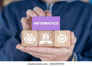 Schoolboy or student holding colorful blocks and sees word: INFORMATICS. Informatics School Computer Technology Science concept.