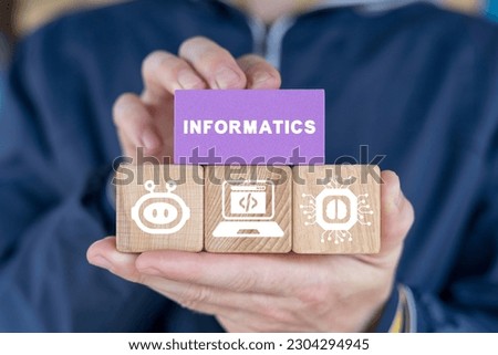 Schoolboy or student holding colorful blocks and sees word: INFORMATICS. Informatics School Computer Technology Science concept.