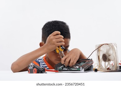 Schoolboy studying Robotic and electronic components at home - Powered by Shutterstock