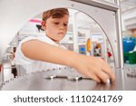 Schoolboy taking part in a science test at a science centre