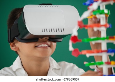Schoolboy using virtual reality headset in laboratory at school