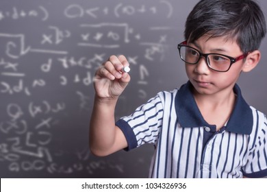 Schoolboy Writing Math Formula On  Blackboard.asian Grade School Student Solving A Geometry Problem On Chalkboard In Math Class, Film Grain Tone