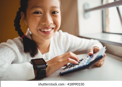 Schoolchild Using A Calculator At School