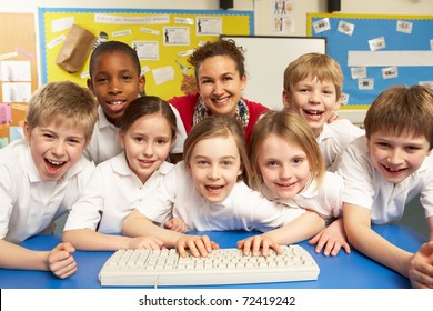 Schoolchildren in IT Class Using Computers with teacher - Shutterstock ID 72419242