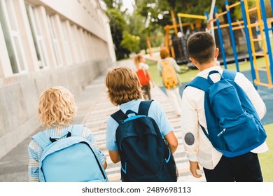 Schoolchildren classmates kids pupils students going together from school home after classes lessons. Education, learning, new academic semester year - Powered by Shutterstock