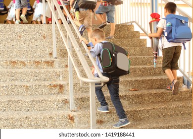 schoolchildren climb the stairs to the school building, the concept is back to school - Powered by Shutterstock