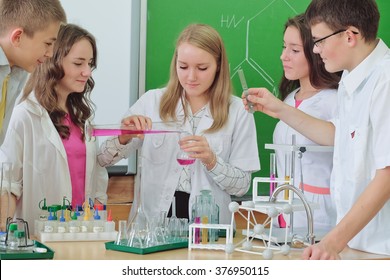 Schoolchildren 

Doing Chemistry Experiment In Science Class 