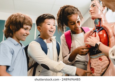 Schoolchildren kids pupils students learning internal organs at biology anatomy lesson on educational dummy at school lesson with teacher - Powered by Shutterstock