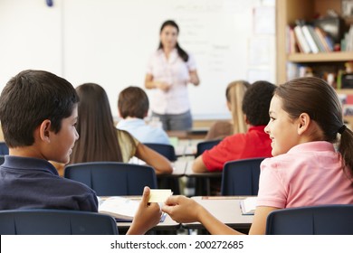 Schoolchildren Passing Note In Class