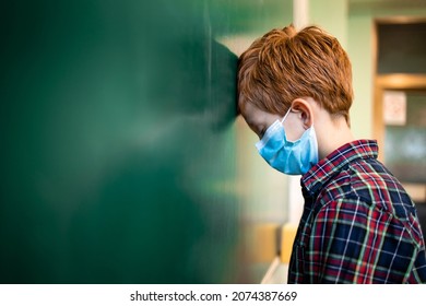 Schoolchildren Wearing Face Masks In Classroom. Impact Of Covid-19 Pandemic On Schools And Learning Loss Due To School Closures During Coronavirus.