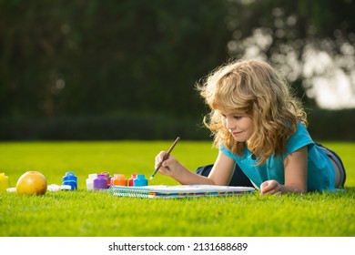 Schooler kids drawing in summer park, painting art. Little painter draw pictures outdoor. Happy child playing outside. Drawing summer theme. Imagination kids. Early childhood education. - Shutterstock ID 2131688689