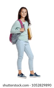 Schoolgirl In Casual Style Outfit Holding A Big Yellow Book Under Her Arm