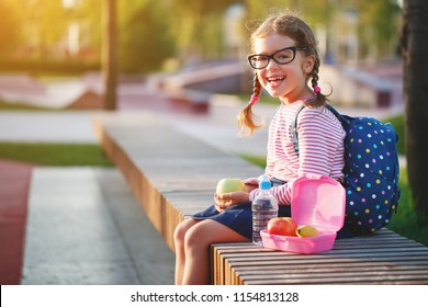 Schoolgirl Child Eating Lunch Apples And Bananas   At School
