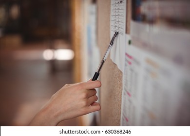 Schoolgirl looking at notice board in corridor at school - Shutterstock ID 630368246