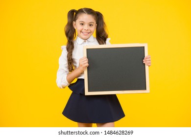 Schoolgirl Pupil Informing You. School Girl Hold Blank Chalkboard Copy Space. Announcement And Promotion. Check This Out. Girl School Uniform Hold Blackboard. Back To School Concept. Do Not Forget.