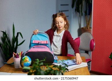 Schoolgirl Put Books And Notes Into Backpack At Home, Pupil Prepare Staff For Education, School Supplies, Back To School Concept.