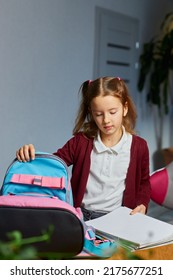 Schoolgirl Put Books And Notes Into Backpack At Home, Pupil Prepare Staff For Education, School Supplies, Back To School Concept.