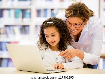 Schoolgirl researching online with the guidance of her teacher