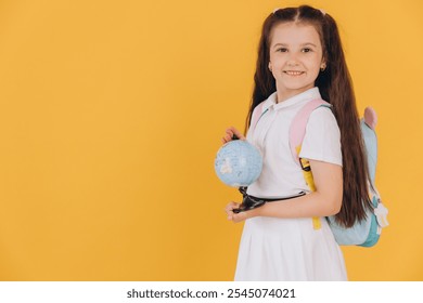 Schoolgirl with a small globe, promoting geography education and global awareness for young students with a smile - Powered by Shutterstock