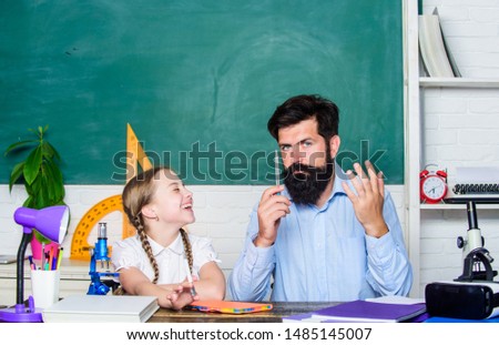 Schoolgirl study textbook. father and daughter study in classroom. education and knowledge. back to school. math geometry. bearded man teacher with small girl in classroom. biology chemistry lesson.
