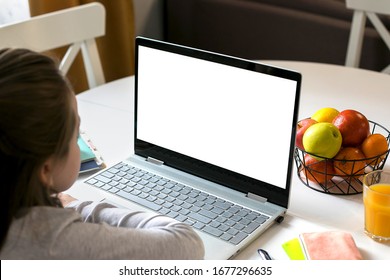 Schoolgirl Studying At Home Using Laptop. Home School, Online Education, Home Education, Quarantine, Coronavirus Concept. Mockup Concept.