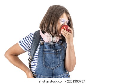 Schoolgirl Takes A Big Bite Of A Big Red Juicy Apple In Her Hand.