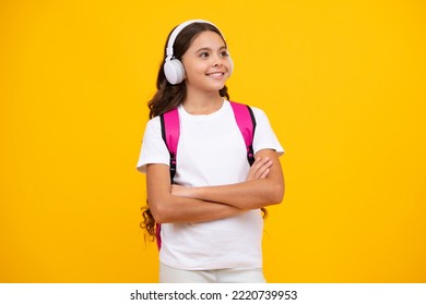 Schoolgirl, Teenage Student Girl In Headphones On Yellow Isolated Studio Background. School And Music Education Concept. Back To School.