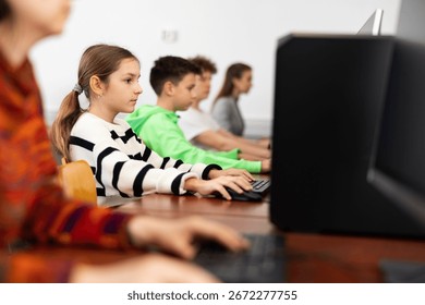 Schoolgirl using computer during computer sciene lesson in school.