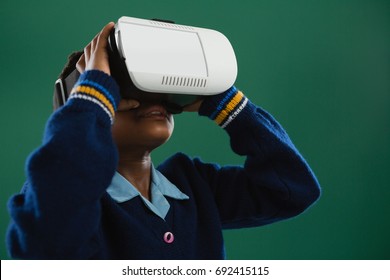 Schoolgirl using virtual reality headset against blackboard - Powered by Shutterstock