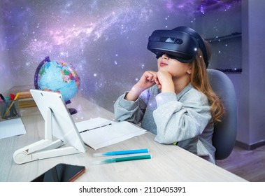 Schoolgirl using VR headset simulators for studying. Child is wearing virtual reality glasses sitting at desk with tablet and watching on sky of stars. Future learning concept - Powered by Shutterstock