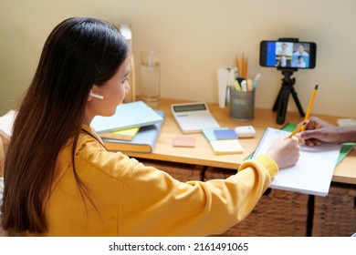 Schoolgirl Wearing Earbuds When Attending Online Class