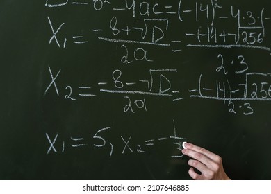 Schoolgirl Writing High School Maths Formula  With Chalk On Blackboard, Math Class Algebra