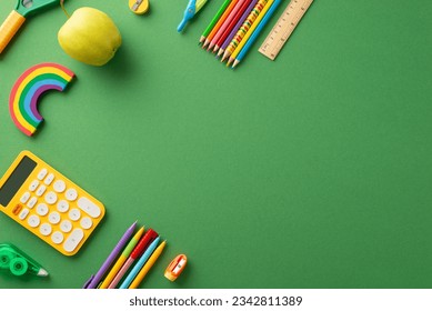 Schooltime essentials: A vivid top-view image of a green chalkboard displaying a delightful arrangement of educational stationary. Ample copy-space available for text or promotional messaging - Powered by Shutterstock