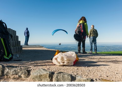 Schwangau, Germany - October 11, 2017: Paragliders on the Tegelberg at the take-off point see a just launched glider afterwards. 