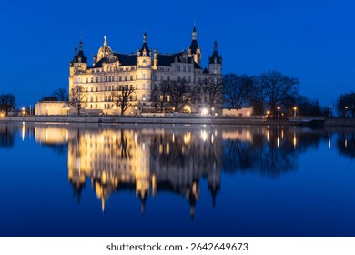 Schwerin, Germany: Dramatic reflection of the Schwerin castle in lake Burgsee at night in the Mecklenburg Vorpommer land in northern Germany