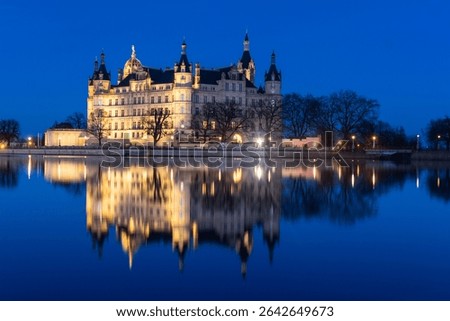 Schwerin, Germany: Dramatic reflection of the Schwerin castle in lake Burgsee at night in the Mecklenburg Vorpommer land in northern Germany