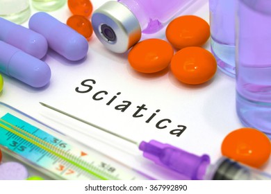 Sciatica - diagnosis written on a white piece of paper. Syringe and vaccine with drugs.