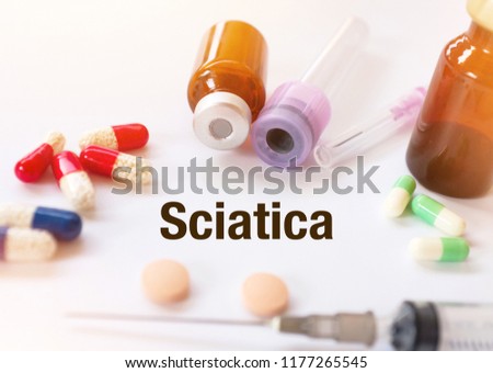 Sciatica - Diagnosis written on a white piece of paper. Treatment and prevention of disease. Syringe and vaccine with drugs. Medical and Healthcare concept. Selective  focus