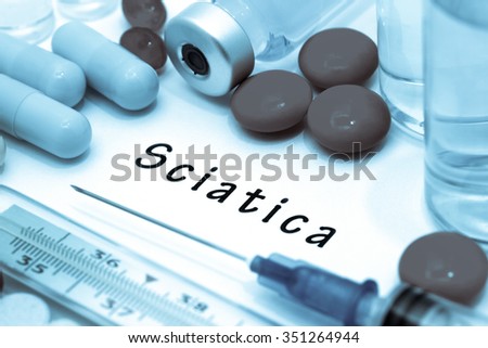 Sciatica - diagnosis written on a white piece of paper. Syringe and vaccine with drugs.