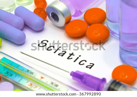 Sciatica - diagnosis written on a white piece of paper. Syringe and vaccine with drugs.
