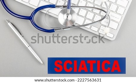 SCIATICA word with Stethoscope on a keyboard on grey background